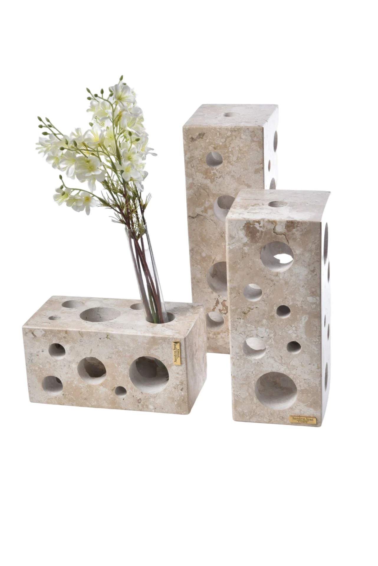 Set of three travertine vases with circular perforations